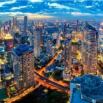 A vibrant view of Bangkok nightlife with neon lights, rooftop bars, and crowded street markets