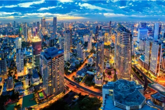 A vibrant view of Bangkok nightlife with neon lights, rooftop bars, and crowded street markets